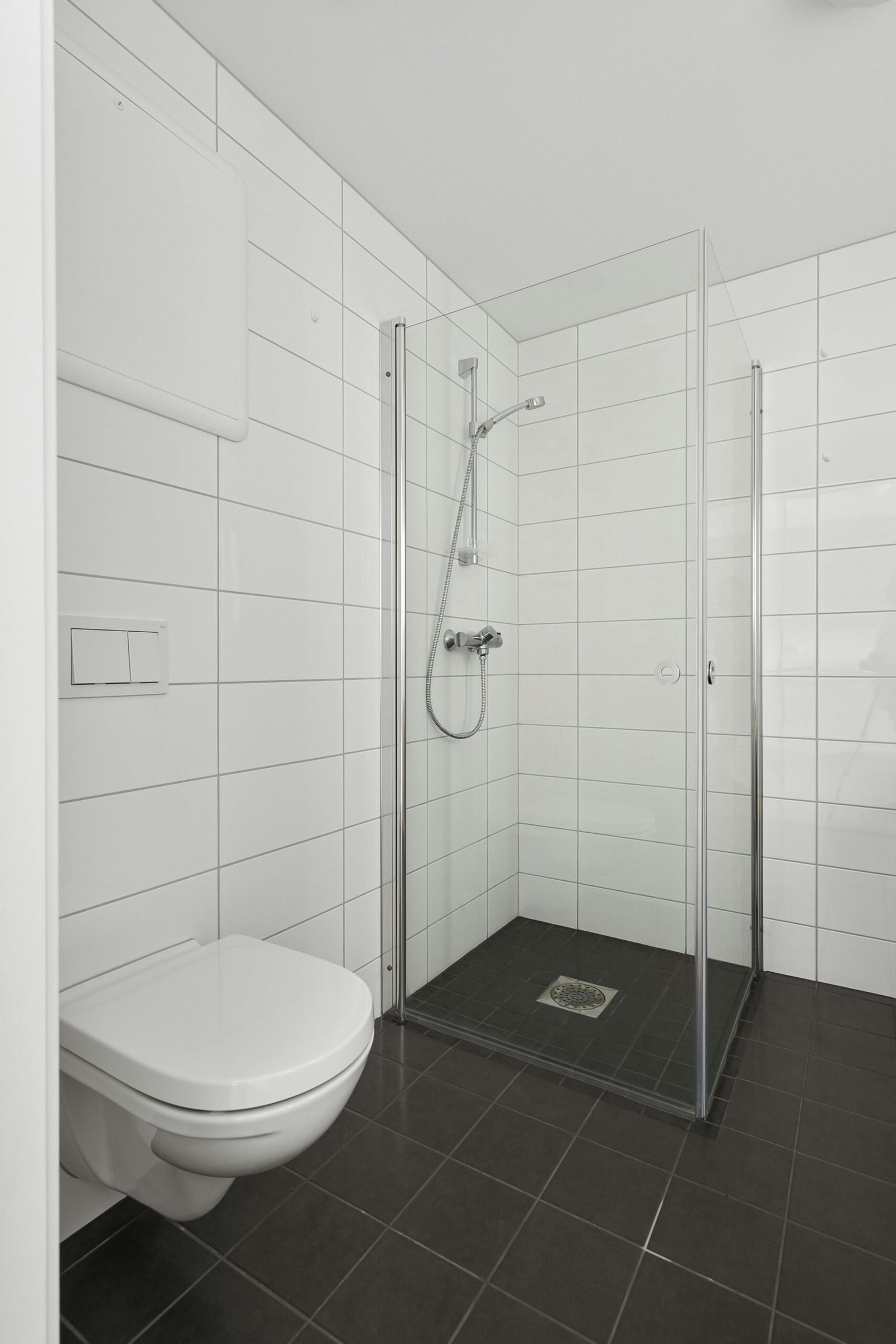 Minimalist bathroom design featuring a glass-enclosed shower and modern fixtures.